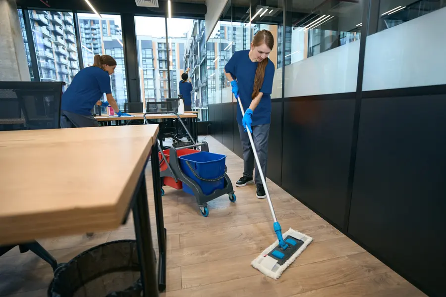 Cleaning crew working through a shared office area