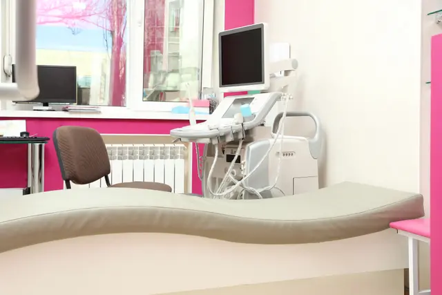A modern medical examination room with an ultrasound machine