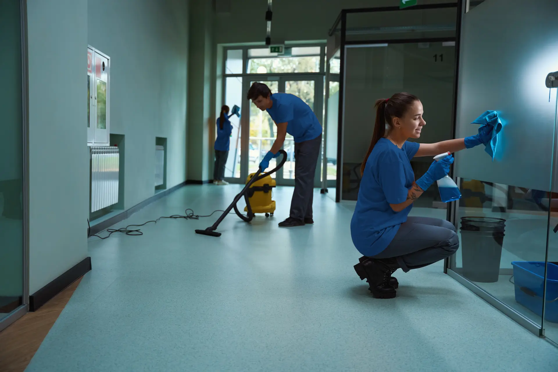 A team of janitors working together to clean a commercial space