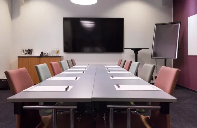 Empty corporate meeting room with a large screen