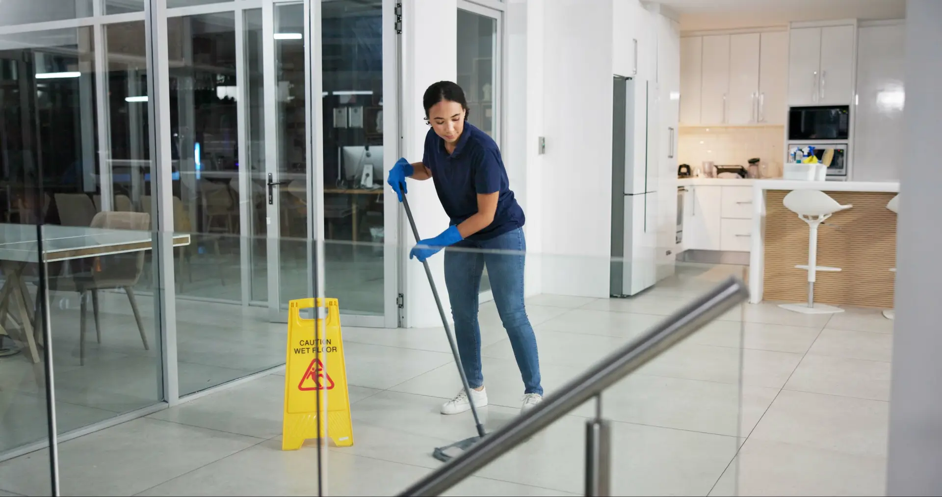 A cleaner mopping the floor of a medical office